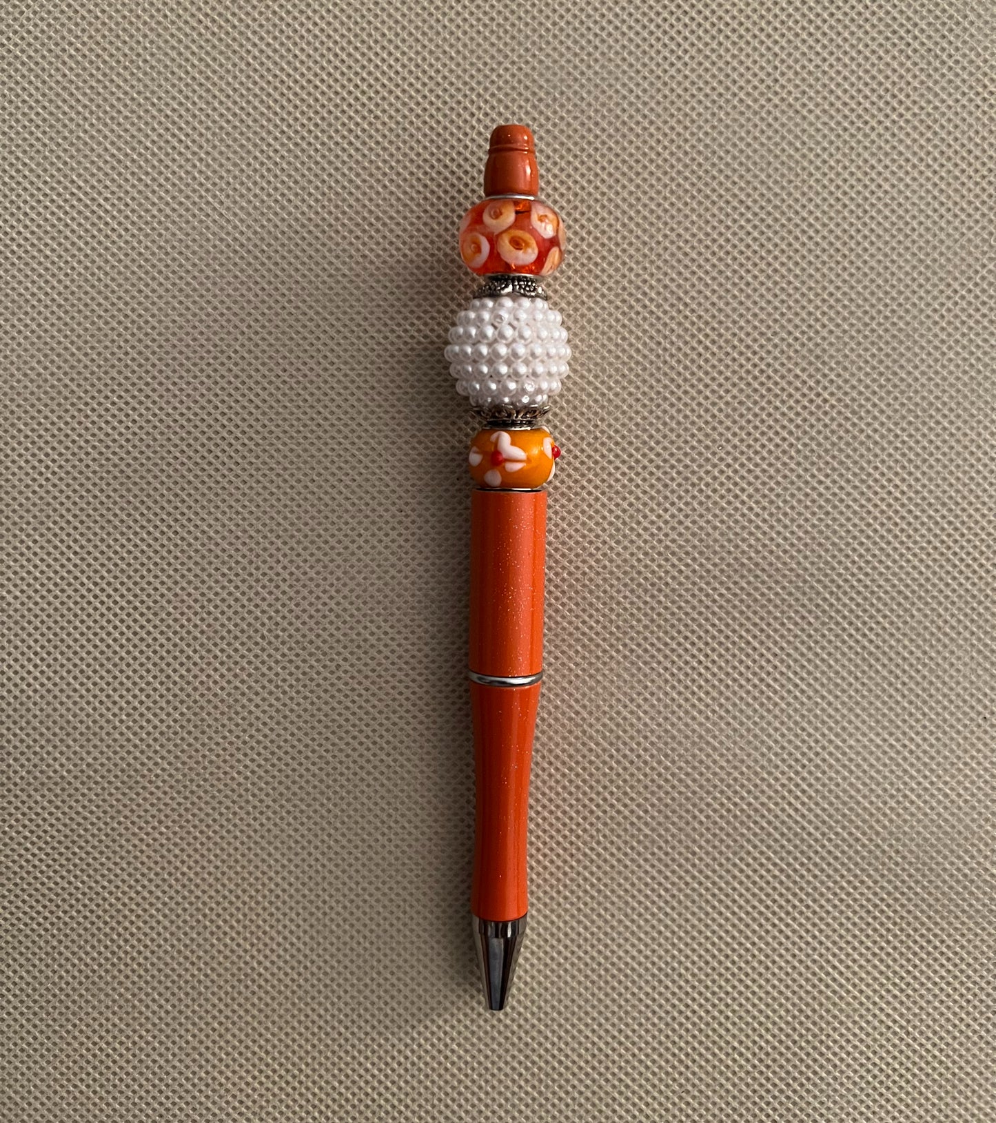 orange beaded ink pen